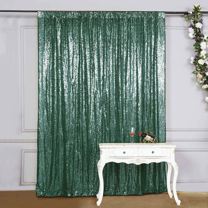 Green sequin backdrop curtain with vintage white table and decor.