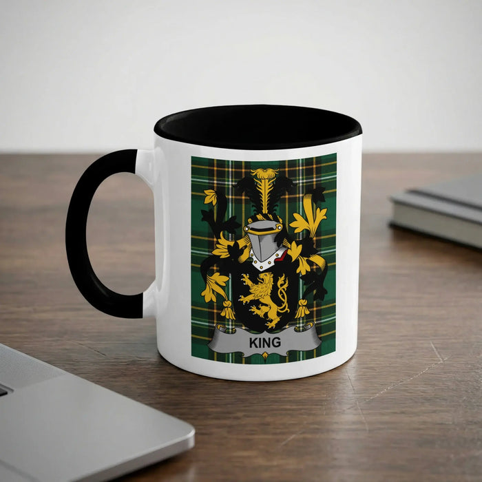 White mug with black rim featuring a coat of arms with the name KING.