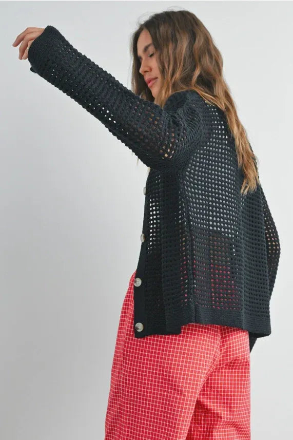 Open stitch crochet black cardigan with buttons paired with red and white checkered pants