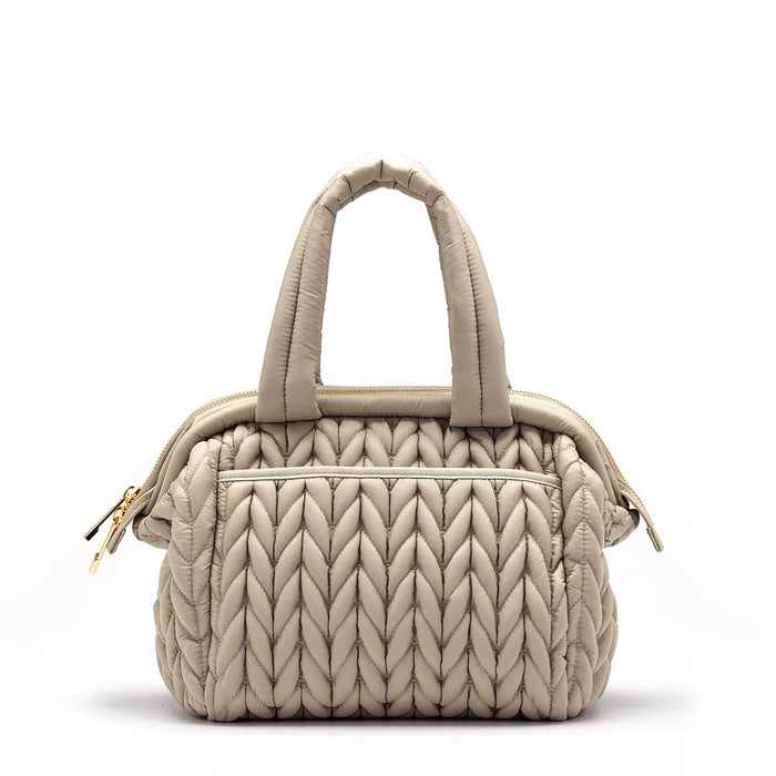 Back view of the Paige Mini Beige, showing herringbone quilting, carry handles, and back pocket with magnet closure.