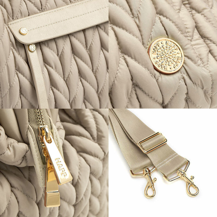 Details of the mommy pocket faux leather trim and zipper pull, gold logo and zipper hardware, and messenger strap.
