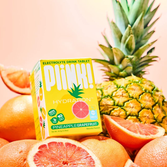 Plim! Hydration electrolyte drink tablet packaging with pineapple and grapefruit on a pink background