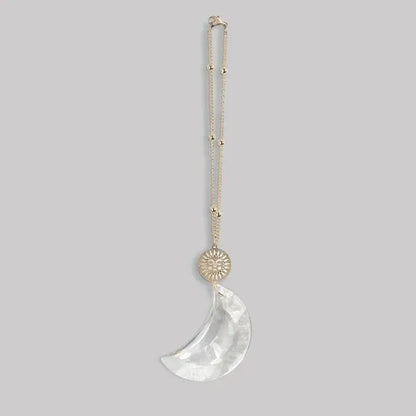 Delicate gold-toned pocket suncatcher necklace with sun charm and clear crystal crescent moon pendant for women’s boho chic clothing