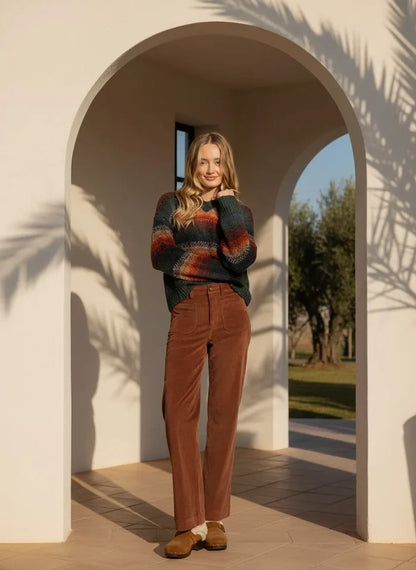 Woman wearing striped knit sweater and brown corduroy Supply Gladys Pants for a stylish look