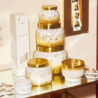 Gold and white speckled glass Volcano Glimmer Signature Candle jars with golden lids